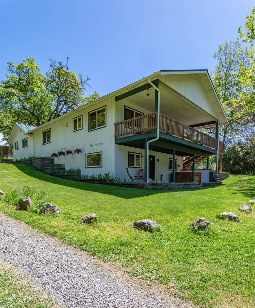 This is one home that you need to come experience! This property has been lovingly cared for over the past 47 years by the same family. The home was extensively remodeled and enlarged in 2006. There are 3 bedrooms and 2 baths on the main floor, a bedroom, bath, family room with a bar on the lower level. This private entrance is perfect for a mother-in-law apartment. The master bedroom is complete with walk in closet and bath. Just off the kitchen is a 10'x23' Trex covered deck for outdoor entertaining. This home sits on 10.8 acres which would easily accommodate horses. If you want additional pets, check out the barn and chicken house. Don't overlook the 20'x24' garage/shop with a 9' high door. You also have a 20'x40' carport. Don't worry about the power going out, there is a back up generator wired into the electrical system for your essential needs. Check out the orchard with apple,pear and nut trees. This is as close as you can get to paradise.