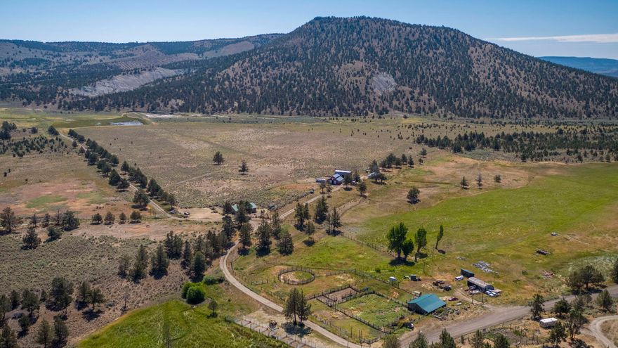 Beautiful cattle ranch located at the base of the Maury Mountains with green lush meadows, creeks, springs, reservoirs, high desert landscape, and ponderosa pine trees. This historic 3,418 deeded ac. ranch is a spectacular display of where high desert meets the mountains. A traditional cattle ranch with the capacity to run 250 pair. Multiple homes are placed across the ranch with just enough space for privacy. The main home is a 4 bed, 2 bth log structure that has been used as a lodge for guests as an additional form of revenue. 65.5 ac of irrigation rights. The property has 10 total tax lots, 9 of which are included in this listing. An additional 160 ac can be purchased separately. The ranch has a private grazing allotment of approximately 6,332 ac of incredible feed. Fly your personal plane to the ranch and land on a registered FAA airstrip located on the property. The ranch boarders both NF and BLM. There are 2 registered fossil beds on the deeded ground. Great mule deer hunting.