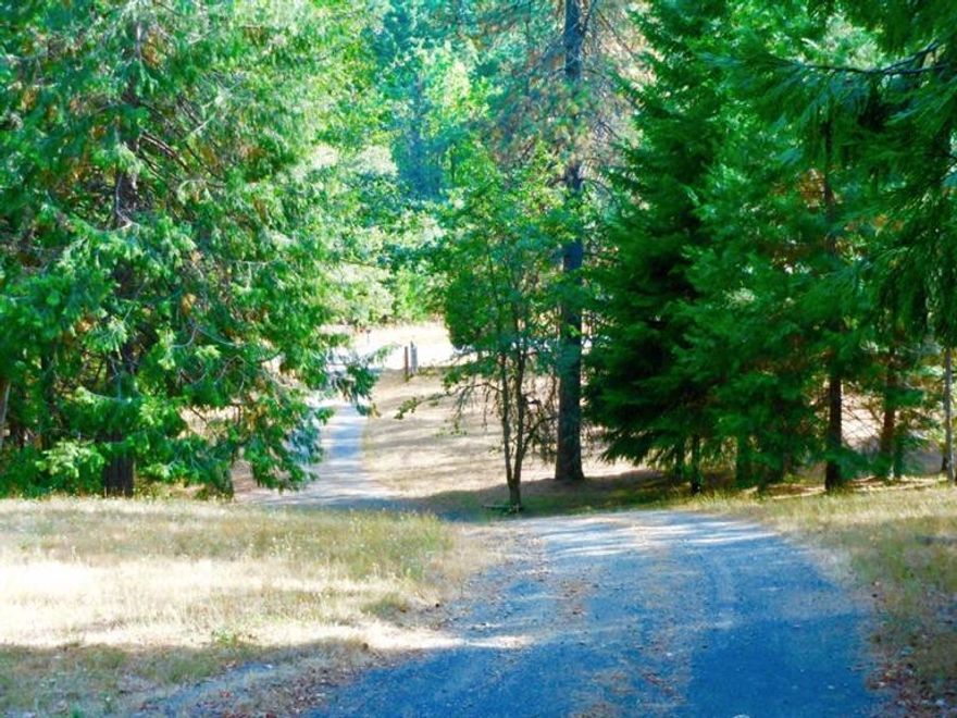 Whether you're Retiring, looking for a two family setup, or just hunting for that great value and perfect get-away this Oregon Shangri-la won't last long. S-E-R-E-N-I-T-Y, privacy, peace and quiet.... This is where you can hear the breeze gently roll through the trees... This wonderful feeling is yours just 15 minutes north of Grants Pass. If you're looking for the perfect retirement or Two family home this is it. This remodeled single level Ranchette has over 2100sf of open living, spacious kitchen, large formal dining room, oversized master, 12x28 covered deck, gazebo, 12x16 storage shed w/covered wood storage, brand new 4 ton heat pump, PLUS an oversized 855sf attached garage w/SHOP and private office, spacious & very cute 640sf 1 bdrm 1 bath Guesthouse for your in-law or visitors PLUS another 2 car attached garage all on 10 private, gated acres. Did I forget to mention the owner says they have a great well and LOW taxes? Now you know. Tour this home and live the Oregon Dream!