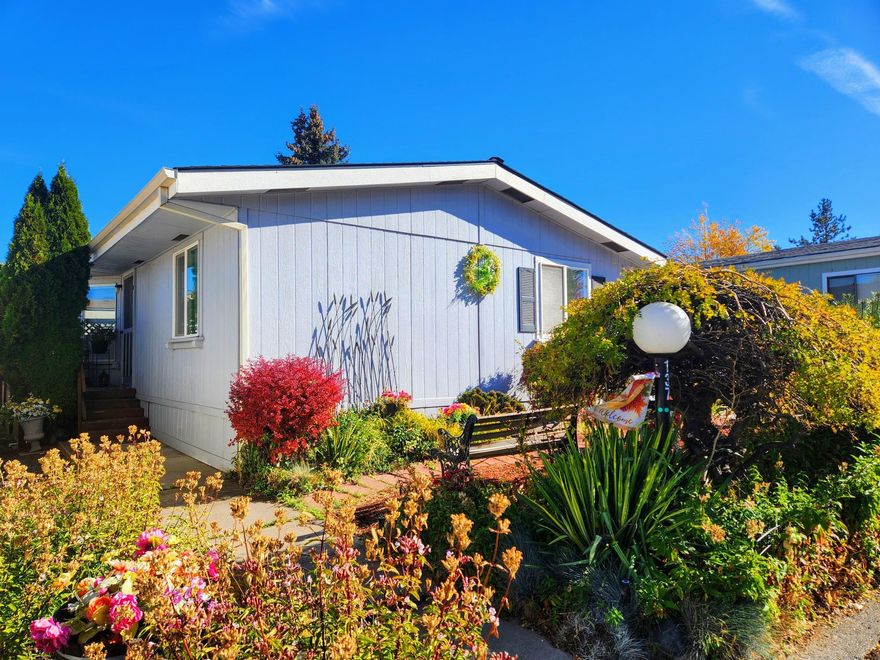 Welcome home to Suntree Village, one of Bend's finest 55+ parks. This home is move in ready, it's light and bright with vaulted ceilings, has a spacious living room with a big bay window, beautiful kitchen with lots of cabinets, beautiful counters and backsplash, kitchen island w/dishwasher and sink and large windows, a large primary suite w/lots of counter space and cabinets including a laundry bin, selves and lg stall shower, and good separation from the other rooms. Also, newer roof, heat pump and a Carport with storage unit and side and backyard. All in walking distance to The Larkspur Community Center where you can swim and exercise. Space Rent is $647.00 mo. includes water/sewer, trash, and use of the Clubhouse. Make an appointment to view today!