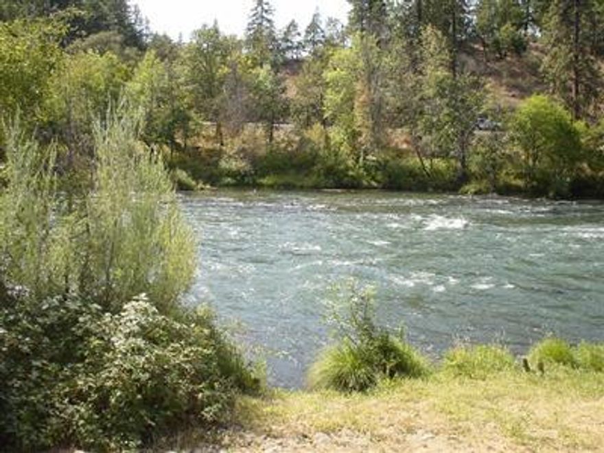 Rogue River front lot to build a home on. Seller just got septic approval, sand filter, 4 bedroom. The buildable envelope will be slightly narrow at ballpark 43 ft across, therefore a two story would be great for this piece. A fence should be put up for privacy. Great opportunity for a hard to find waterfront lot. Neighboring piece is listing for $329,900 and property backs to BLM.