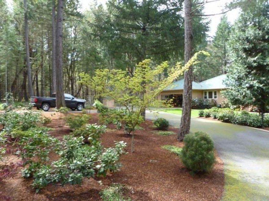 Here is the perfect Oregon Dream home and it is move in ready! With tall trees all around & beautifully landscaped yard, it provides the perfect start or ending to the day. Obviously a lot of love went into updating & maintaining this property. From 2005-2013, there were continuous updates & improvements made. Granite was added to the kitchen & bathrooms, stainless appliances, cultured Marble shower surrounds, hardwood floors, heated floor in master bath, metal roof, generator & epoxy floor in garage are just a few upgrades & that doesn't include the gorgeous yard! The perfect U shaped kitchen is very easy to work in. Enjoy the front view while relaxing at the table in the eating area or the tall trees off the deck in the back. There are 2 bedrooms, 2 baths with 1159 sq. ft. on 1 acre, just the right amount of space to take care of & enjoy to the max. Garage has work area with an epoxy floor & room for two cars. There is also RV parking, a security gate & a paved driveway.