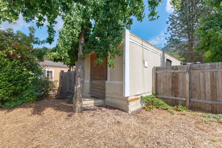 Cozy one bedroom, one bath, 576 sq foot mobile home in all ages park is full fenced for your privacy. Mobile has been professionally cleaned and ready to move in. In need of some paint and floors, if you choose.  Washer/dryer hookups (washer/dryer not included) available in unit. Park is quiet with beautiful views of surrounding mountains and the Rogue River right across the highway. Seller is motivated.  This park is pet friendly so bring your fur baby!