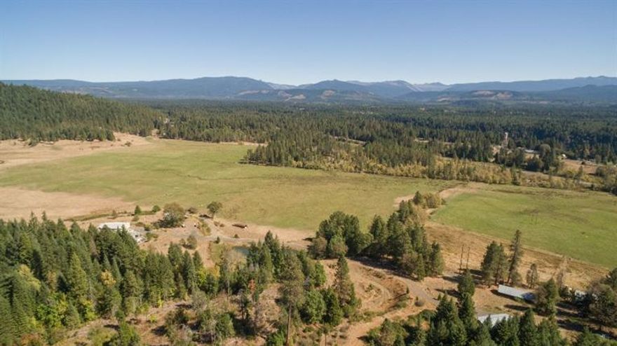 Amazing Ranch property with 163.87 acres. Panoramic views, privacy, WATER, pasture land, 120 irrigated acres with wheel lines & hand lines & gravity fed, approx $500/year for water , gravel pit, pond, 60x60 feeder & storage barn, 60X30 metal shop w/ 11' doors, detached 35X24 garage, 68X21 machine shed, 32X14 RV storage, dog kennels & chicken coop. Main house is 2007 built manufacture home with 3 bedrooms plus an office, 2.5 baths. Huge open kitchen with alder cabinets, large island w/ sink, Wolf gas range oven w/ 4 burners & a griddle, mud room, formal dining room, vaulted ceilings, formal living room & family room. Lg master suite w/ door to back deck, walk in closet, dbl sinks, soaking tub & walk in shower. 2nd home in not livable & is in need of major repair. Owner of this amazing property also gets 2 land owner elk cow tags per year! 2nd Home site has expired but buyer to do due diligence with county to get it back.