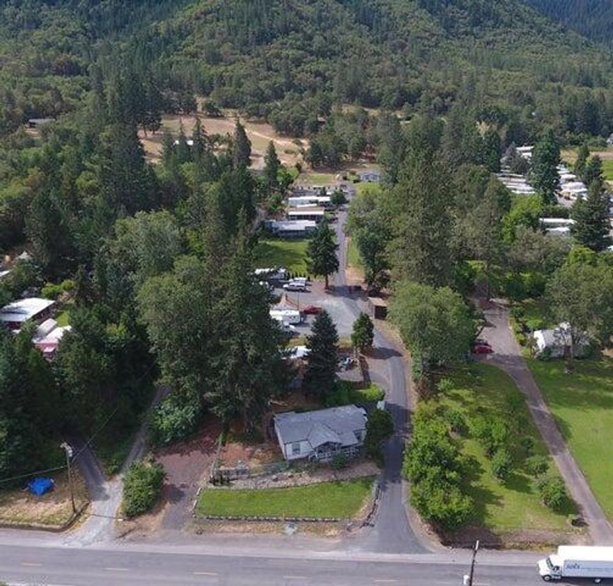 ''5 Acre Mobile Park'' A very clean and well kept family park with All Homes & RV's owned by the tenants. This low density Class 3 MH Park has 10 MH & RV spaces w additional rent income. County Policy for this MH Park allows for 50% expansion by approval, and has a DEQ Septic approval on file for 4 to 6 additional spaces. Located on Rogue River Hwy, 3 minutes from Rogue River, 10 from Grants Pass, 25 from Medford and right across the road from the Rogue River with a picturesque mountain backdrop. This is a low risk, low maintenance income property with a 6+/- CAP Rate as run based on an adjusted 2024 YTD Pro Forma P&L. Can be a high 7+ CAP Rate brought up to current market rents and potential 9+ CAP after expansion. This well maintained, State Licensed MH Park has an excellent tenant base and stable income with minimal turnover. No one wants to leave. Also for sale is the adjacent 4.88 ac property w 4 rentals and could offer further expansion possibilities. Buyers to do Due Diligence