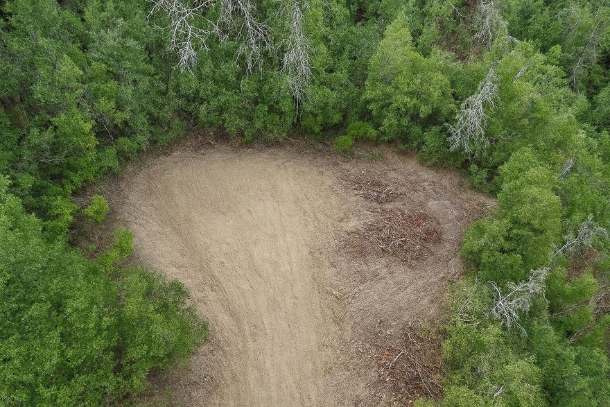 When was the last time you felt surrounded by nothing but whispering trees, endless stars, and the kind of quiet that feels like magic? Your hidden retreat may have just revealed itself: 27.25 wooded acres tucked into the serene hillsides of the Applegate Valley. Here, deer slip silently through the trees, songbirds fill the mornings with music, and woodpeckers echo their rhythm against the oaks and pines.On this county-approved homesite, you can build to transcend the ordinary and redefine forest luxury—embracing serenity, comfort, and a deep connection to nature.  Living ''in the trees'' can feel like a cozy cocoon wrapped in fir.The site has a driveway, septic perc holes ready for testing, and power at street level. Trails from the last logging era weave through the property, linking you to vast BLM land for endless exploring.