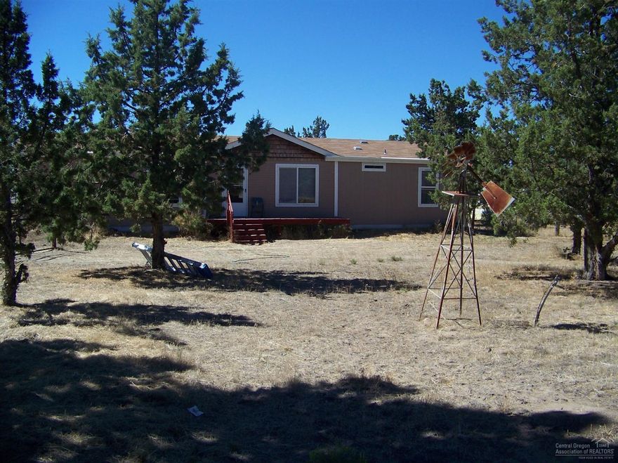 Affordable housing on a good size property. This home has potential and can be very nice. Lots of privacy and in an area of good mountain views to the West. Home is financed with a private lender who would consider continuing with a qualified buyer. Tie down straps are installed.