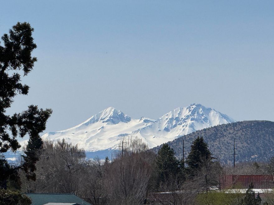 Prime one-of-a-kind canyon rim property in the heart of Redmond with cascade mountain views and direct access to the dry canyon trail system, concert venues, parks, & pickleball/tennis courts. The city of Redmond has informed us this property is a good candidate for a townhome development, a cottage development, or potentially a multi-family or higher density development. The city also mentioned that SDC credits could potentially be available. This great location offers all essential desirable amenities, with schools, shops and restaurants within walking distance.  The classic 3-bedroom home has a ton of character with good bones and potential to be remodeled into a lovely home that would help preserve Redmond's historic value.  Development properties in locations like this are very rare. Bring your creative ideas and take advantage of this one-of-a-kind property.  Property is being sold as-is.