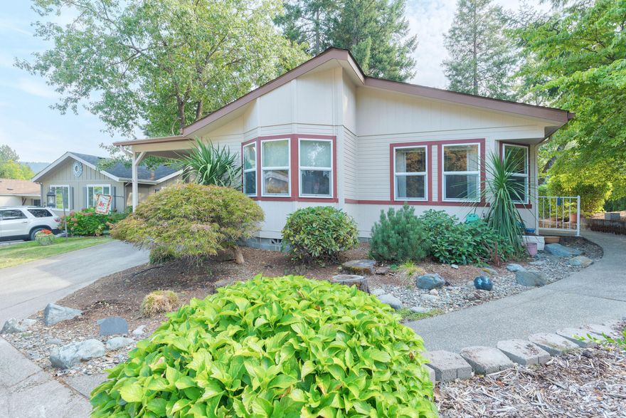 Welcome to the Newest Listing in Highland Heights MHP, A 55+ Community.  This spacious 3-bedroom, 2-bath manufactured home offers 1,518 sq ft of comfortable living and end-of-the-road privacy. Built in 1997, the home features a formal dining room with arched entry, a well-appointed kitchen with a center island, and generous counter space—ideal for everyday living and entertaining. The stately primary suite includes a private bathroom with double sinks, a soaking tub, and a separate shower. Updates include stylish laminate flooring and a cozy gas stove in the living room. Step outside to enjoy the private deck, perfect for summer afternoons. The landscaped yard features automatic sprinklers, a storage shed, and a tandem carport. Park is on well water. Monthly space rent is $850. 1 pet, must be park approved