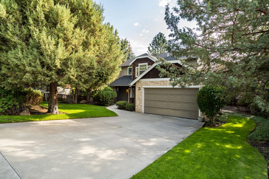 Nestled on one of the quietest streets on Awbrey Butte, this Northwest Craftsman-style home enjoys an enviable location less than five minutes from downtown Bend and just a half mile from the Deschutes River Trail. An incredibly private lot with mature trees and low-maintenance landscaping offers a peaceful retreat in one of Bend's most sought-after neighborhoods. On the main level, abundant natural light and a living room with a gas fireplace complement a formal dining room, powder room, and a kitchen with oak hardwood flooring, granite island, glass subway tile backsplash, and spacious pantry. The upper level features two bedrooms and a full bath alongside a primary suite with a soaking tub, double vanity, and walk-in closet. In addition to a covered front porch, a shaded back deck offers the perfect space for outdoor dining with easterly views, while a two-car garage provides ample storage.