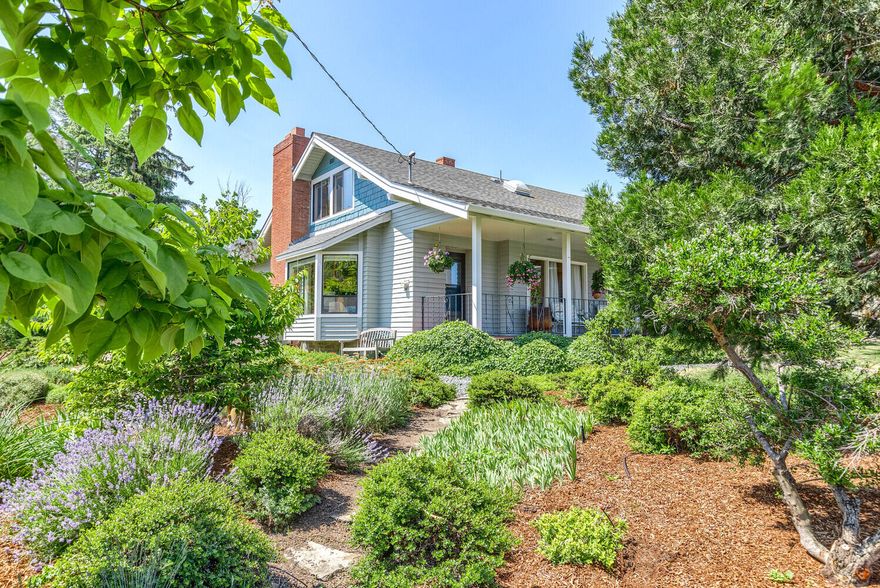 Welcome to this charming Ashland home situated on a nearly half acre corner lot and located near Helman School & Bear Creek Greenway.  The property boasts a large kitchen with matte finish granite counters and a built-in pantry wall.  As the heart of the home the kitchen opens to a cozy family room.  There is a separate living room as well as a bonus room providing great flexibility.  Excellent storage is throughout. From the large front porch enjoy beautiful flower gardens with winding paths. In the backyard there's a large, picturesque & usable flat grassy area along with a generous patio; a haven for relaxation and outdoor entertainment.  And don't miss the chicken coop! A wonderful stone wall surrounds most of the property.  Just a lovely setting!  The oversized, two car garage has a workshop area and lots of storage. There is lot split or ARU potential.  Check with City Planning. The 4th bedroom has its closet just outside it in the hall.