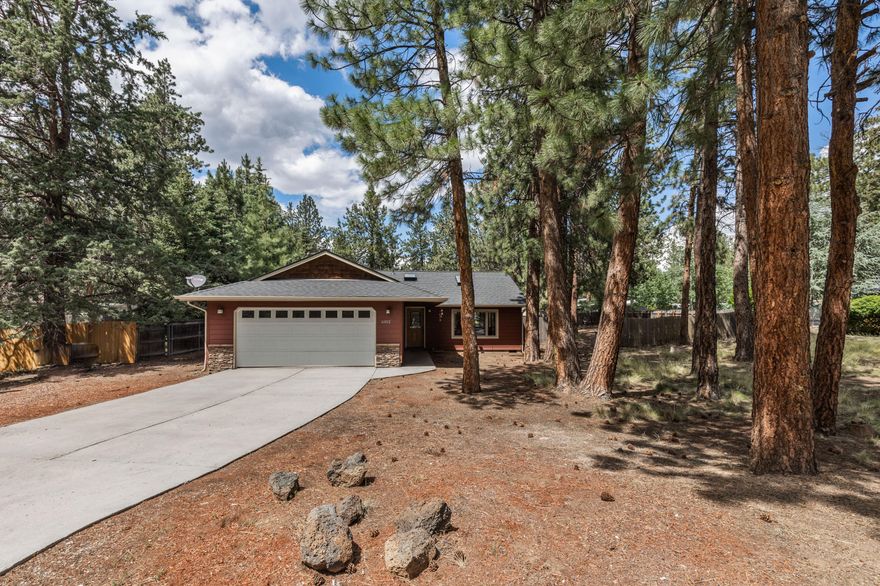 Beautiful updated single level home on a large .41 acre lot in desirable SW Bend.  This home features hardwood floors, a vaulted living room with skylights, gas fireplace with rock surround, wood wrapped windows, three bedrooms and primary with ensuite.  All bathrooms have been updated with tile counter and hardwood cabinets. The rear windows look out over the landscaped, private, fenced back yard with large mature trees.  Roof was replaced and skylights installed in 2019 and driveway was redone in 2018.