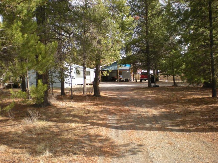 2 Bedroom 1 Bath Manufactured Home that has been well maintained. Covered Front porch for extra space. Large RV cover with additional side for carport, storage room behind.