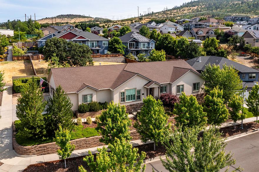 Custom-built single level living w/designer finishes & upscale features throughout. This thoughtfully crafted 4 bed, 2 bath + a bonus room includes hardwood floors in the living areas, stylish plantation shutters & a seamless open-concept floorplan. Gourmet kitchen complimented by granite countertops, a farmhouse sink, full-height tile backsplash, walk-in pantry & adjacent laundry/mud room. It opens gracefully to the living & dining areas, w/direct access to the expansive back patio. Spacious living room showcasing a trayed ceiling, built-in cabinetry & a gas FP w/stone surround & wood mantle. Handicap friendly home w/widened door frames & hallway for ease of movement. Large primary suite w/double-door entry, vaulted ceiling, 2 walk-in closets & ensuite w/a dual sink vanity, tile shower & soaking tub. Year-round outdoor living on the covered back patio that spans the length of the home. Fully fenced w/mature, easy-care landscaping & additional walk-in storage space under the house.