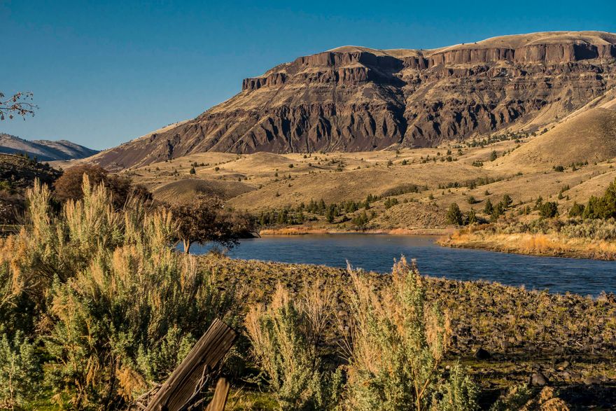 You will never get tired of the expansive horizons and towering vistas of this amazing landscape! Set along the banks of the mighty John Day River this historic ranch encompasses 6,397.27± deeded acres, plus BLM grazing permits covering an additional 2,663± acres, with the John Day River winding along and through the ranch for 4.5± miles. Additionally, adjoining BLM land grazed by the neighbors totals 3,741± acres along another 4.5± miles of John Day River frontage, accessible only from the river, or adjoining private lands. There is a residence, power and water at the ranch headquarters. If you are an avid hunter, or angler, this ranch is for you. It is one of the few ranches that boasts the rare combination of quality upland gamebird, waterfowl, and big game hunting, plus fly fishing for steelhead and smallmouth bass!