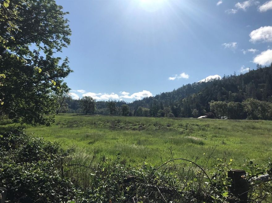 Serene open pasture lined by year round Evans Creek. Excellent sun exposure and soil with 57+acres of free irrigation rights dating back to 1881. The irrigation is piped underground and pumped from Evans Crk. Lrg irrigation pump and raiser sprinklers are included. There are 2 pounds and signs of run off from Springs in Mountains. There is a 3960 SqFt barn, a 1216 SqFt building and 2 old homes left to hold home site. An Old utility barn that needs rebuilding. 2/3 of 579+ cares is forested mountains with current and future timber value of a variety of trees. Miles of roads and trails for hiking, riding and hunting. The 4 tax lots that total the 579+acres are zoned EFU and WR. There is one gated access across a solid bridge to the entire property which offers security to this private ranch.