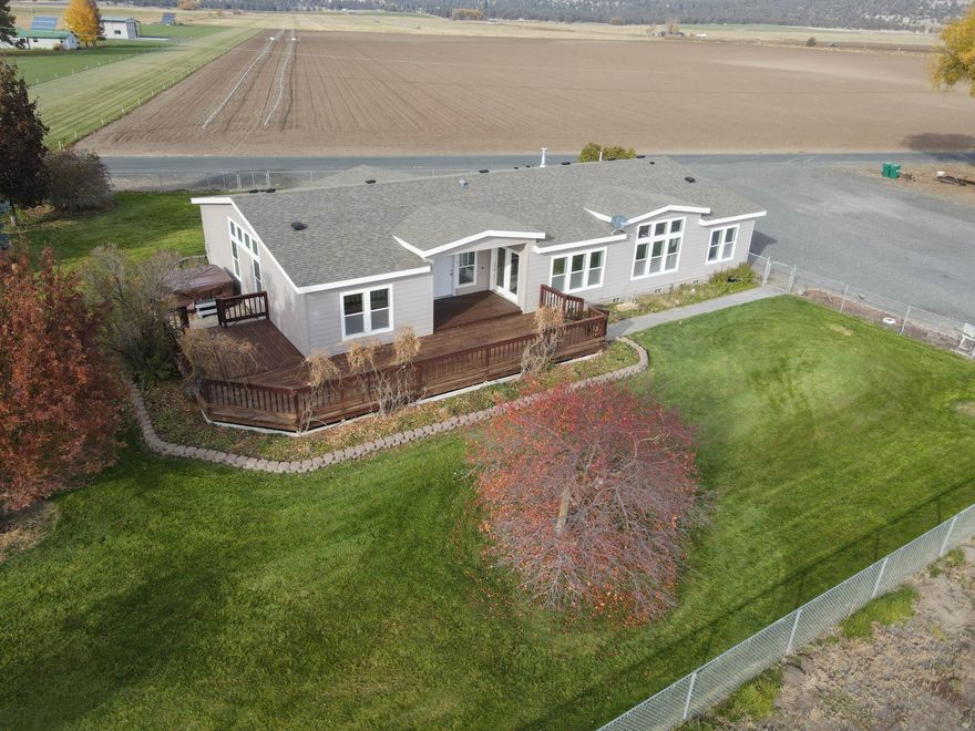 Two Homes on acreage in Bonanza!!  Rare opportunity to own two homes situated on four lots totaling 1.65 acres.  The main residence is a spacious 2001 MF offering 4 bedrooms, 3 baths, and 2785 sq. ft. of living space.  Remodeled Primary Bath with tub and shower, large walk-in closet and bonus room in Primary bedroom.  Freshly painted inside and out this home is move in ready and features a nice lawn area with mature trees and a shelter and pen for livestock.  There is a 24 x 36 insulated detached garage/shop with bonus room, electricity, concrete floor and metal roof.  The second home is a 1920 stick-built structure with 784 sq. ft. ideal for guests, rental income or multigenerational living.  Both homes are in good condition, each with its own well and connected to city sewer and Avista for natural gas.  Plenty of space, versatility, and value all in one property!