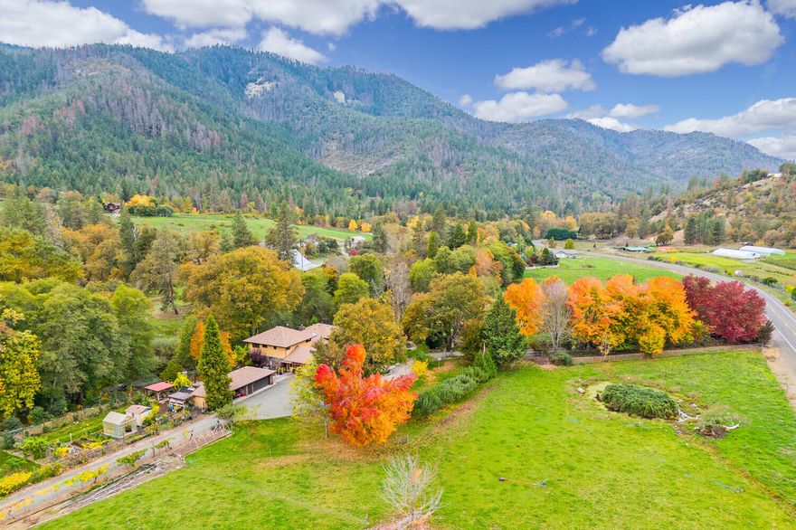 Picturesque ranch property located on the Little Applegate River w/approx. 1/2mile of low bank river frontage, separate guest cottage, additional 1-acre approved homesite, irrigation rights & beautiful gardens. Gated, tree-canopied entrance, approx. 5000sf barn & expansive river side home w/solid wd drs & Koa wd accents throughout. Spacious primary rm including soaking tub, dry sauna, dbl walk-in closets & French style drs to expansive decking. Formal living & dining, center island kitchen w/slab Granite cntrs & large walk-in pantry. Second level family rm w/open beam vaulted ceilings & French drs to private deck. Separate guest wing includes 1-bdrm/1-bth w/kitchenette & private entrance, new dual HVAC units w/electrostatic air filters, new laminate flooring, wd framed windows, skylights & natural stone accents. 3-car detached grg, wonderful outdoor entertaining areas, inground pool, walking paths, fruit trees, grape arbor, greenhouse and raised beds. Your own private Shangri-la!