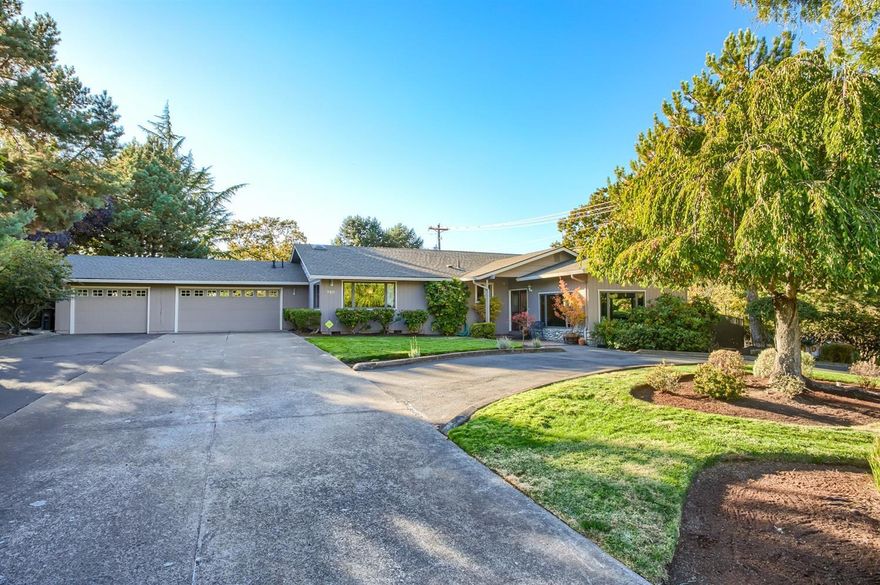 Enjoy spectacular views of of Roxyann Vineyard from this .41 acre private park like setting. This charming 3 bed 2 bath has vaulted wood beam ceilings and large windows with new low E Glass. The floor to ceiling windows offer gorgeous views from the kitchen and family room as well as the back yard. The large kitchen has updated cabinets, granite counters and an island with bar sink and counter seating. The Kitchen opens to a family room area that leads to the patio and pool. The formal living room is equipped with an efficient remote stone fireplace. The large dining room has been updated with cabinet space for your storage needs. The floors are solid wood with walnut inlay and Karastan carpet. The back yard has lush mature landscaping and is completely private with an in-ground pool with new pebbletech finish and new fencing. There is ample parking with a circular driveway, 3 car finished garage, and room for RV/Trailer parking.