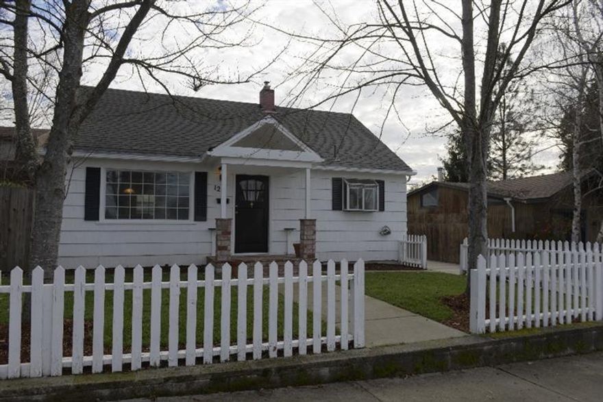 Cute older East Medford charmer with white cedar shakes, black shutters, covered front porch with brick columns, white picked fence in front yard with new lawn in front & back with large fenced backyard with alley access to RV parking or 3 cars. Many new updates from all new carpet, new range w/ glass cook top, newer heat pump, & new exterior paint & new interior paint. Main home that is 1212 sq ft w/great den/office off master suite upstairs, plus studio that has a wall A/C & heater built in Studio with lg walk in closet and good size laundry room with large sink and hobby area in laundry room. 3rd bedroom or great hobby room in detached studio . Zoning is MFR-20 for multi family. Studio was used for many years as a business called CruiseOne. Listing agent is a seller & related to co-seller.