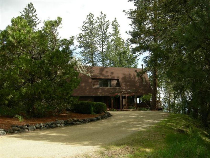 A terrific location & GREAT view of the Vally, City lights & Mt McLoughlin. Close to downtown Jacksonville (approx 1 ml) in a forested, rural setting. This is a nicely maintained property & should not be passed up! Updated Kitchen w/Maple wood floors & a Breakfast nook that overlooks & provides access to your outside deck, offering views of the Valley & mountains, even the tip of Mt Thielsen. Vaulted ceiling, Formal Dining, spacious Living Room w/deck & yard access w/a beautiful wood burning rock fireplace. Plenty of windows to enjoy the surrounding forest & city lights. Double door formal entry w/access to 1/2 bath, garage access & hobby room or possible 4th bedroom, Family Room w/certified wood stove, deck access to hot tub. Master suite & 2 additional BR's, 2nd full bath, den/study, & deck access on the upper level. Wrap around driveway, garden area and shed off entry. A 'must tour' property, minutes to downtown Jacksonville. Adjacent 5.4 acre lot is available MLS 2954644