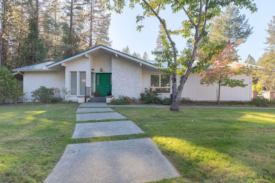 Welcome to 1.08 acres of peaceful living and country charm! This 1,883 sq ft home features 3 bedrooms and 2 bathrooms—including two ensuites—offering comfort and flexibility for families or guests. The spacious living room centers around a cozy double-sided fireplace, perfect for relaxing evenings, while the country-style kitchen comes fully equipped and ready for your personal touch. Step outside and fall in love with the mature landscaping, ideal for entertaining, gardening, with plenty of room for your animals. Bonus features include a finished, heated 30x20 shop & greenhouse ideal for hobbies or storage and the greenhouse is equipped with water and drip system—ready for your green thumb or creative projects. This is your chance to enjoy the charm of country living and make this home truly yours. Come see the possibilities and create your dream home!