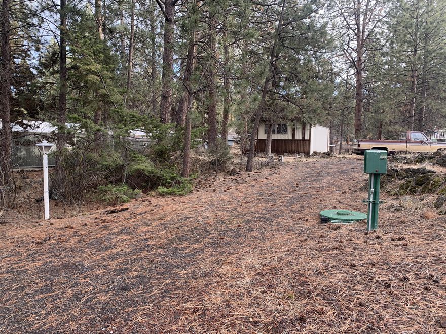 .38 acres of affordable living in Bend, Oregon!  Less than 2 miles to Old Mill and the river trail, minutes to highway 97, and within walking distance to a park, this is ideally located for all that Central Oregon has to offer.  This lot is unique in Romaine Village because the owners opted out of the HOA years ago so there is no HOA assessments on this lot.  Ready for your creativity and imagination to be expressed, this property has many options.  Buyer to do due diligence to understand potential development options.