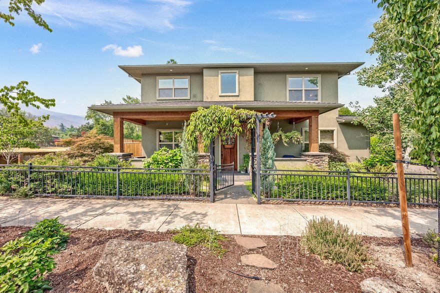 This home is absolutely perfect for all your entertaining needs & offers surprising privacy throughout. Lovingly maintained, including kitchen & bathroom remodels. The kitchen is a Chef's dream w/ 6 burner Wolf range, double ovens, wine fridge, grand granite counters & walk-in pantry. Open floor plan w/ new wood burning fireplace, set in a stone surround in the large living room. Stunning Nano doors lead to an all seasons framed in patio w/ 'out door kitchen' & access to the in-ground solar heated pool w/ 3 water features & in ground hot tub. Main floor also has an office w/ true built ins + a sunroom.  Upstairs are 2 primary suits & 2 additional large bedrooms. The main vaulted primary offers a terrace deck, a true spa bathroom w/ tiled shower, jetted tub.  2 car attached garage plus a 3-car detached garage (some stalls are heated). The 480 square feet guest studio above the garage is ideal for overflow guests. Room for all your RV parking. Don't miss this rare Ashland Opportunity.