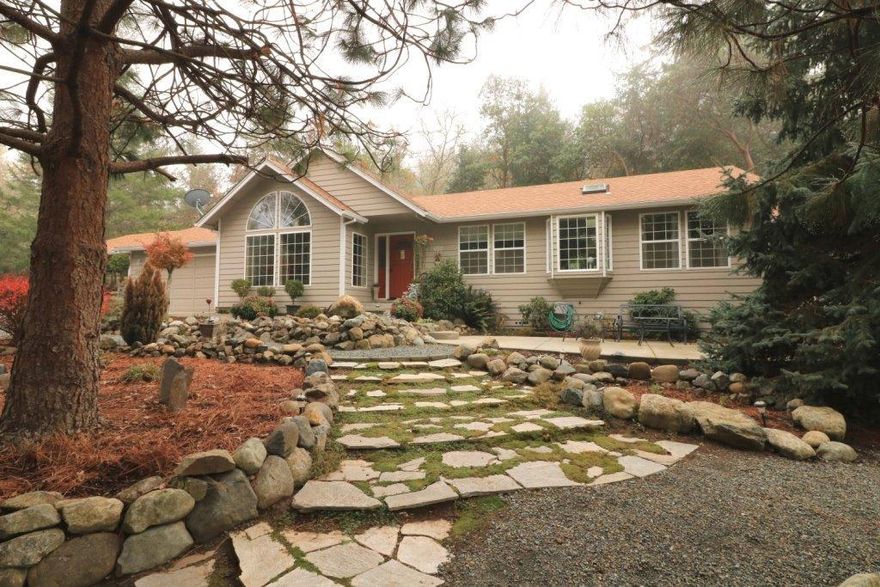 Count your Lucky Stars... this is the home you've been searching for! Immaculate 3 bedroom, 2 bath home with a comfortable one level floor plan. With off the road privacy, you can sit back and relax with 1.36 acres of natural surroundings, trees and views. You'll enjoy the spacious living room with lots of windows, dining room and kitchen for family and entertaining. Rough edge granite counters, appliances, desk space, and island complete the kitchen. Additionally, a lovely master suite and two bedrooms and main bath complete the package. Features include beautiful wood flooring, tile, a private back deck, attached garage and carport, plus room to park an RV. Landscaped with great care, this property will be easy to maintain with pavers, stone walkways and more. A great location with a country feel, yet close to shopping, medical facilities and town all with county taxes. Pride of ownership shines through inside and out. From the moment you drive in you'll want to call it home!