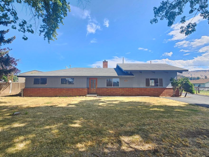 Country atmosphere with 1.6 acres just outside of town! Spacious ranch-style design. The additional features like a paved parking area, two-car garage, and separate workrooms offer great convenience. The barn and cross-fenced property provide opportunities for gardening or keeping animals, while being close to town adds the benefit of accessibility to amenities. It is a perfect blend of country living with urban convenience!