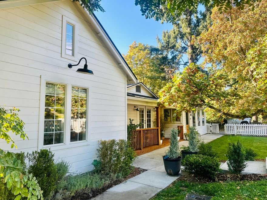 Enter into a turn key beautifully renovated home in 2017. Extensively updated and 1,000 new sq ft added. This Jacksonville Cottage was built in 1946 and features an all one level living space with 5 bedrooms and 2.5 baths with a total of 2,128 sq ft. Located in the heart of downtown Jacksonville with stunning views out your front window of the historic Touville House B&B. 2 blocks from shops and fooderies and a short stroll to the Britt festivals. Start your day off with a coffee in the sunroom and enjoy the homes features of laminated wood floors, tile floors, Quartz counter tops, top-of-the-line KitchenAid appliance, gas cooking range, a double sided fire place, den and living room, a new large deck out back with a sunken hot tub added in 2023. Perfect for outdoor entertainment. Beautiful and a must-tour home offering easy, elevated living. Setbacks allow for a building of a garage. Proceed with due diligence with city planning department.