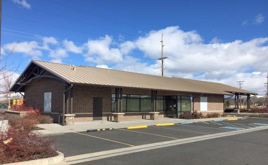 Former bank branch building in excellent condition and located on a corner lot with good visibility on a busy intersection across from a Super Wal-Mart Shopping Center. Approximately 115' of Washburn Way frontage. Newer building (2007) with two covered drive-through lanes: One with drive-through window; the other was previous drive-through ATM lane. Metal roof and fully landscaped. Private offices, kitchenette, & 22 dedicated parking spaces. ADA accessible. Lot is nearly one-acre with room for additional parking or potential expansion (to be determined as part of a buyer's due diligence for intended use). Square footage per County is 3084 sq. ft. Square footage per ALTA Survey is 3120 sq. ft.