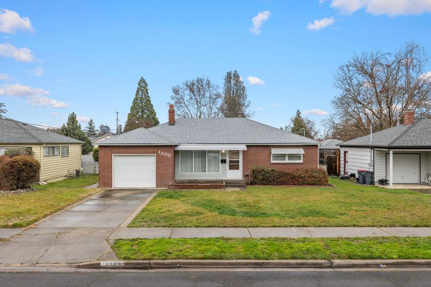 Discover the epitome of single-level living at this three-bedroom, one-bath home on a serene street. The classic brick-style exterior exudes timeless charm, complemented by a convenient one-car attached garage. For extra versatility, a detached shop awaits, perfect for additional parking, storage, or even as an RV haven with hookups. Enjoy the ease of alley access and relish the pleasant surroundings of this delightful neighborhood. Welcome to a home that seamlessly combines practicality with classic appeal.