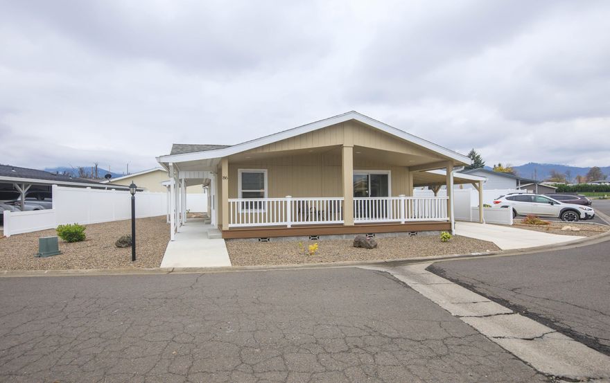Built in 2022, this Marlette home shines with modern comfort & thoughtful design. Offering 1,344 sq ft, the floor plan lives large, thanks in part to a versatile den with French doors that's perfect for work, hobbies, or cozy movie nights. The kitchen is open & inviting, featuring a pantry & stainless-steel appliances. Generous windows & an eye-catching architectural ceiling add a stylish lift to the living room. The dining area flows seamlessly onto the showstopper front porch through sliding doors, ideal for morning coffee, evening relaxation, or effortless indoor-outdoor entertaining. The primary suite includes a faux-tile step-in shower, double sinks, & linen storage for convenience. With low-maintenance landscaping, a storage shed tucked under the carport, & guest parking right next door, the home is designed for easy living. Just steps from the park office & the community pool, this bright, sunny home brings together comfort, convenience, & contemporary charm. It's a standout!