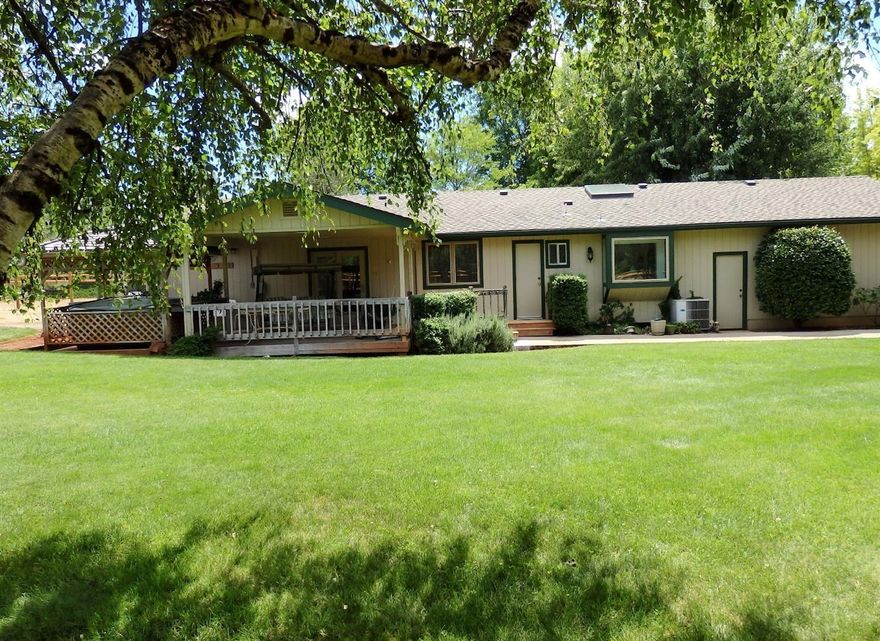 Are you a car lover, or maybe you just need lots of room for toys? This is definitely the property for you! Picture this: Beautiful lite & brite contemporary home featuring 3 bedrooms, 2 baths, pellet stove in large welcoming living room, parquet entry, dining/family room, ceiling fans, solar tubes, Pella windows w/interior mini-blinds, remodeled kitchen w/maple cabinets, skylites, granite tile, stainless appliances (including Fisher & Paykel dishwasher) & garden window, instant hot water, large master w/2 closets + adjoining 9-1/2 x 23 closet/hobby room, French doors to the deck from 2nd bedroom, also w/over-sized walk-in closet/storage room, plus 3rd bedroom/den, guest bath w/updated vanity & lighting, & attached, finished 2-car garage. The large covered deck features a hot tub for your enjoyment & allows you to take advantage of the pastoral views & privacy. Most of the 2.75 acre property is fenced & there are multiple fruit trees. Outbuildings include 10x20 studio w/storage cabinet