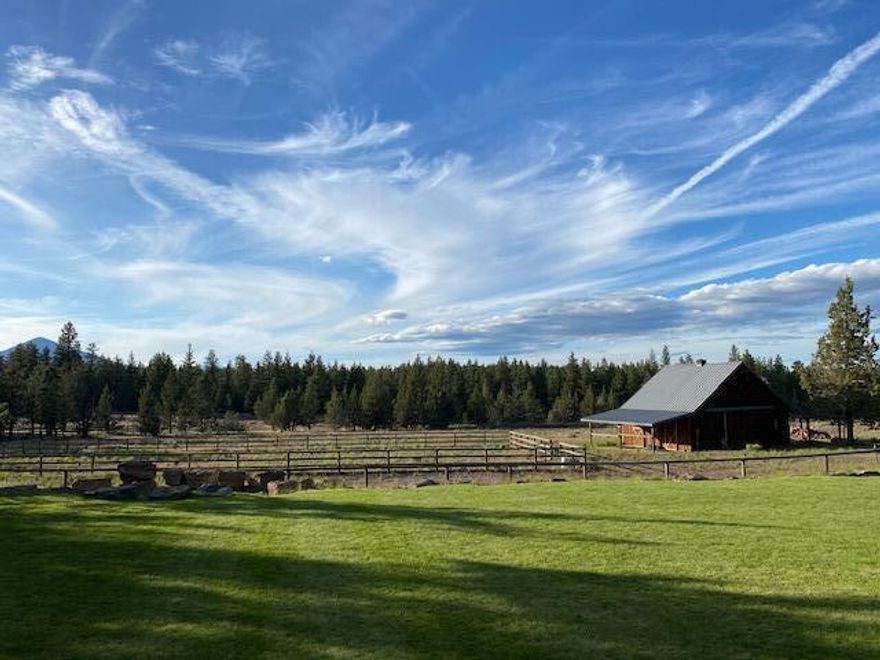 Welcome to serene country living with direct access to 160 acres of public lands and less than two miles to the thriving town of Sisters, Oregon. Relax on 9.6 private acres with clear views of Mt. Jefferson & Black Butte and over three hundred days of sunny skies. Appreciate the pastoral and forest landscape while you lounge by the pond with a dock, waterfall, sand beach, and firepit. Livable and spacious, yet simple to maintain, this 3,998 Total SF Pacific Northwest Craftsman has 4 bedrooms and 2.5 baths in the main residence plus an additional detached office/ studio with a kitchenette, full bath, and private entrance. Let your horses and pets run and graze in the fully fenced property, outdoor arena, and paddocks. The 2-stall barn has a center aisle, hayloft, and insulated 250 +/- SF tack room/workshop. Ample parking for vehicles, farm equipment, and recreational toys. Conveniently located within 30 minutes of Bend and the Redmond Airport. Enjoy Central Oregon living at its finest!