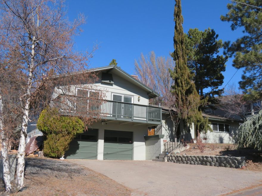 Custom home, built in 1967, tri level. 2,700+ sq ft includes 4 bedrooms, 3 baths, (2 primary suites) All on same level! Large living, dining & kitchen are full of light and incredible views of valley, mountains and sunsets. Large yard full of trees ready for your green thumb. Good off-street parking for toys. 2 car garage. Media/office/playroom or home gym (large). Well loved. The bones, room sizes and location are wonderful. Inspections done!