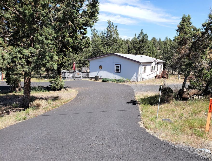 Well kept manufactured home on 2+ acres close to town. This cozy home features a large deck suitable for entertaining. Detached 2 car garage with workbench, a carport and separate RV hookup. Home has 4 solar tubes installed for improved lighting. Corian counter tops. Dog friendly with pet dogs and a small dog run.