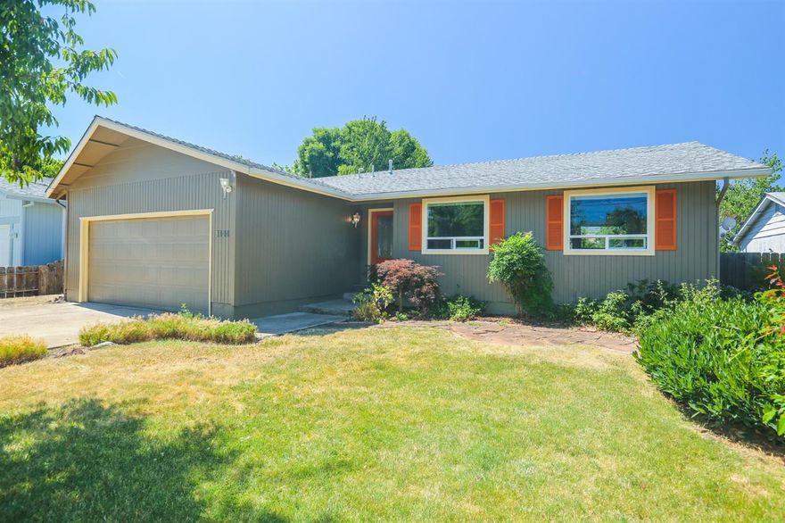 This clean single-level home in Talent not only has curb appeal but it lives much larger than you'd expect and it's in a great location. Step inside and you'll notice a bright and open great room seamlessly connected to an oversized deck with mountain views. The professional landscaping includes drip irrigation, sprinklers, mature beds, and a large Cherry Tree in the front. Imagine spreading out with three bedrooms including an owner's suite and two guest rooms with another full bath. Use all three bedrooms or keep one as an office. Recent decking and paint upgrades. All hard surfaces including tile, hardwood, and laminate. No carpet in this home. Laundry/utility room is between the kitchen and the garage and may not be included in the total square footage. Buyer to verify. Call for more info and come take a look because this house won't last long!