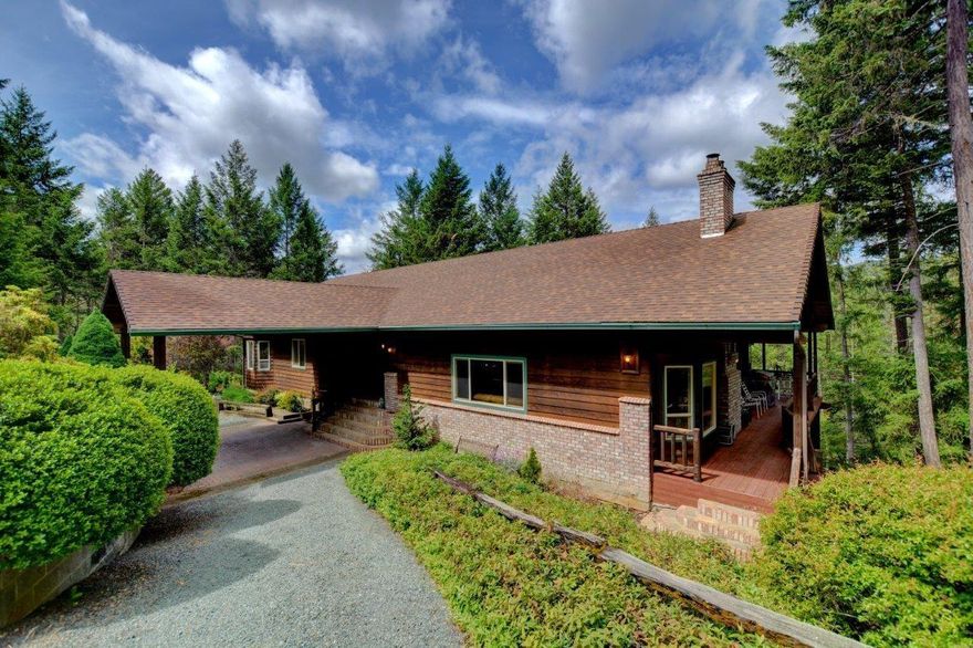 One of a kind and KING OF THE HILL! This fabulous home, with over 3900 square feet and sitting on 5.06 private gated acres is the true Oregon Dream. The location is ideal - treed and at the end of a cul de sac the peaceful presence will draw you in. There is a porte-cochere at the front entrance and most of the living space is on the main level. Open beam ceilings, fireplace, large dining with built ins and a terrific kitchen with many custom features; breakfast bar, skylight and desk area. Large covered wrap around decks are perfect for entertaining no matter what time of year. The master suite is large with full bath and there are 2 more bedrooms and full bath as well as large laundry/utility room on the main level. There is a daylight basement featuring a separate entrance with wet bar, shop area and full bath. Perfect for the home office or mother in law. Two separate heat pumps, RV and toy parking galore!