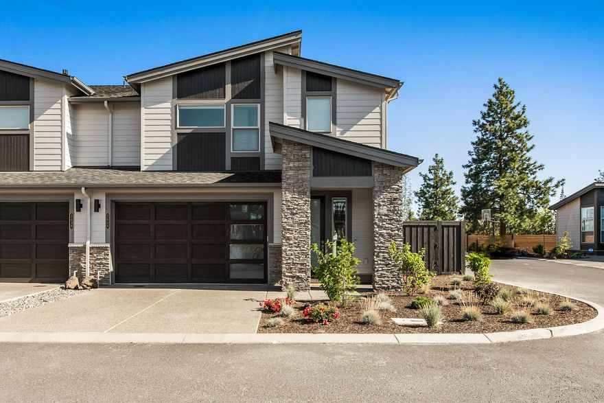 Thoughtfully positioned on a private corner lot, enjoy the privacy of no neighbors on one side or behind you. Pristine town home is located in a private gated community with private river/river trail access. Home showcases elevation that lets you gaze out over the tree tops and enjoy the views of the city and tree line. Great room design maximizes its square footage w/luxury finish work throughout including hardwood floors, trendy tile, white cabinets, slab counter tops and elegant lighting. Rear patio features custom fire pit and allows for privacy and pets, with low maintenance yard. HOA covers front yard landscaping and snow removal for care free or second home living. Enjoy direct access to the river trail and walk or bike to downtown. Exceptionally maintained and offering private low maintenance living minutes from town, trails and parks!