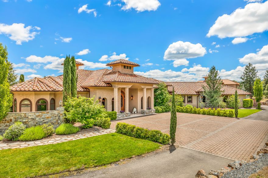 Surround yourself in the lap of luxury w/ this Southern Oregon Tuscany Estate. Located in the West Hills of the Rogue Valley just minutes from Historic Jacksonville, home of the Britt Festival & local wineries. Watch the sunrise over the Cascade mountains & enjoy the amazing views from this knoll top setting, overlooking your own hobby vineyard. Attention to detail around every turn in this over 5000 sq ft, 4bd, 4.5bth custom home w/ attached 3 car garage, plus detached 1860 sq ft oversized 3 bay barn w/extra living above for accommodating your out-of-town visitors. Enter the main home through stone & pillar column entrance w/ arched French doors, leads into grand foyer. The multi-faceted ceiling design encompasses this home adds to the open floor plan & artistic details. Imported light fixtures are among the many high end features. Custom wine cellar & workout room. Enjoy the large outdoor living space w/ infinity pool & spa, covered outdoor kitchen, blt-in butcher block & pizza oven