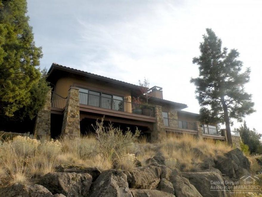 Top quality, single level Awbrey Butte home with fantastic views from Mt Bachelor to Mt Hood. The home has been architecturally designed for comfortable living and easy entertaining. Enjoy the wraparound paver deck and outdoor living area with wood burning fireplace, hot tub and outdoor shower. The indoor living area includes a chef's dream kitchen, great room with fireplace and large windows, a library/game room, exercise room, and luxurious master suite, 2nd master provides a great place for guests.