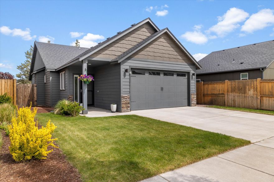 Move-in ready SE Bend charmer delivers the huge backyard you've been dreaming of. Inside, fresh finishes—quartz counters, stainless appliances and central A/C—let you unpack and relax on day one. The single-level layout centers on an open kitchen and a generous primary suite featuring double vanities and a private slider to the patio. Step outside to an entertainer's paradise: a covered patio for year-round BBQs, an expansive fenced lawn, raised beds, and sunny space for play, pets, or a garden. The yard has two large trees perfectly placed to hang a hammock. A flat driveway, 2-car garage, washer, and dryer add effortless convenience. Set on a quiet street blocks from Pettigrew Park and just minutes to the vibrant Reed Market dining scene, Larkspur Community Center, shopping, and trails—this home pairs unbeatable location with turnkey livability.