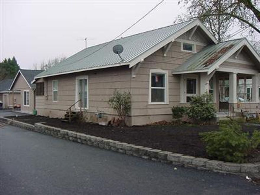 A blend of the old and the new. The front house, with 2 bedrooms and 1 bath, was built in 1910 has charm with its covered front porch but also has an updated kitchen with oak cabinets. There are pergo floors, high ceilings, and an enclosed back porch. The new unit in the back has polished concrete floors, 986 sqft, 3 bedrooms, 2 baths. Back unit is vacant. Great 2 family set up. Both units are one floor. Units on one tax lot.