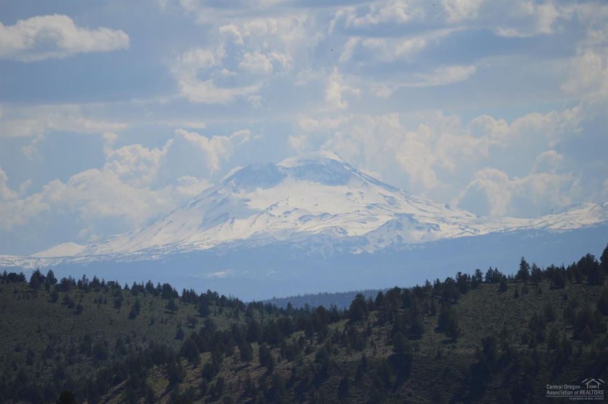 Million Dollar Westerly Cascade views from this 5.2-acre lot with services installed. You must tour this lot to appreciate the private, serene setting. Shared well installed, with separate water meters and recorded agreement. Septic installed for 3-bedroom home and never used. Power to well house. Lot is flat and then slopes to lower level where drainfield is installed. This gives you the unobstructed Cascade and Canyon wall views that very few properties enjoy, while also providing access to lower level. Driveway and building push-out have been roughed-in, so you can let your imagination run wild! A small portion of this properties rear property line intersects with miles and miles of public land, for your recreational use! Access to the beautiful Steelhead Falls on the Deschutes River is nearby. Join this thriving community and enjoy all the amenities; golf, swimming pool, disc golf, tennis/pickleball and river fishing, not to mention the nearby lake sports!