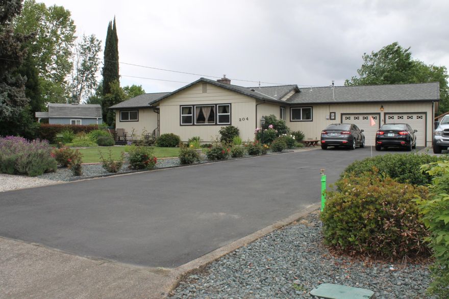 Rare Gem-Beautifully landscaped, well maintained home in a quiet cul-de-sac on almost a third of an acre. 4 bedroom/2 bath with a nice sized living room and a certified fireplace insert. Custom tongue and groove patio enclosure opens up to yard, patio and workshop. Workshop has power, air conditioning and wired for 220. For the RV and big toy enthusiasts, there is ample RV parking with an access gate and RV dump plus additional parking in front of the gate.  Some of the updates include new double pane windows, kitchen update (2020) both bathrooms updated, roof (2014), garage door with high access rails (2018), new workshop (2015) and driveway resealed (2018). Seller will provide a First American Home Warranty ($440)