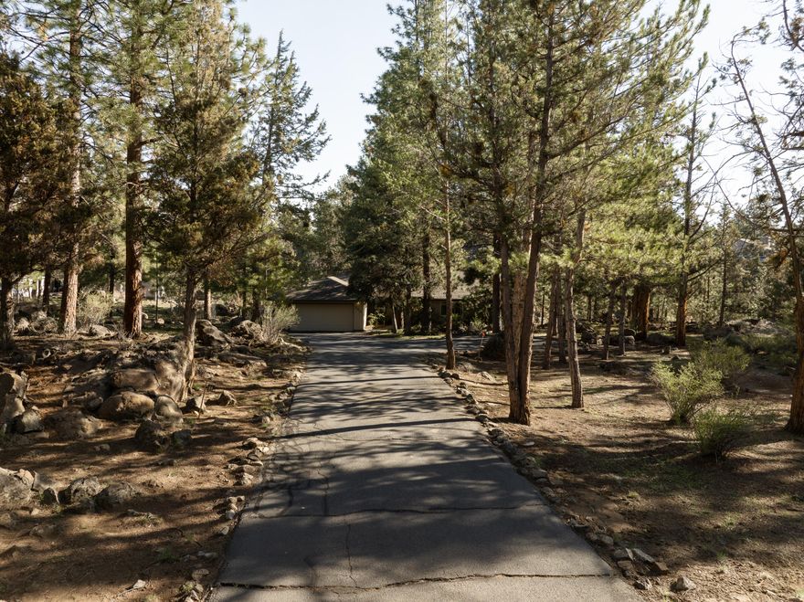 Tucked into the tranquil Rimrock West neighborhood in NW Bend and nestled along the Deschutes River, this home offers an exceptional opportunity to own a legacy home. Here you will find a lovingly maintained home with spacious rooms, hardwood floors, vaulted ceilings, and beautiful river views! This desirable single level boasts floor to ceiling windows, vaulted ceilings, and a pellet stove in the spacious living room, a nicely appointed kitchen with high end appliances, a primary suite overlooking the river, bathrooms with tiled floors, soaking tubs, and tiled showers, a huge laundry room, and an attached two car garage, along with additional parking under the tall gorgeous pine trees on a .83 acre lot. Enjoy dinners on the deck or windows open on summer evenings with the soothing sounds of the rushing water. Properties like this one don't come along very often!