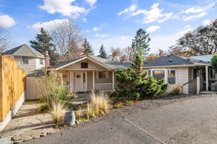 Charming storybook home on a quiet street just a few blocks from historic downtown Jacksonville & miles of walking trails. The home has a warm & comfortable feeling with a functional floorplan & lots of windows for natural light.  The home features primarily main floor living; the main floor includes a LR w/ a new gas fireplace insert, open to a kitchen w/ a spacious dining area, office, large laundry room, three bedrooms, & two bathrooms. Upstairs features a bedroom/bonus room. 
A covered patio is located off the back of the house that overlooks the fully fenced, spacious landscaped backyard which is perfect for entertaining. Enjoy morning coffee on the covered front porch with a tranquil water feature. Recent updates include a newer roof, HVAC, upgraded electrical with 400 amp service, and a 220 outlet for an EV charging port in the detached oversized garage. A 21X21 detached studio provides ideal space for a home office or hobbies.