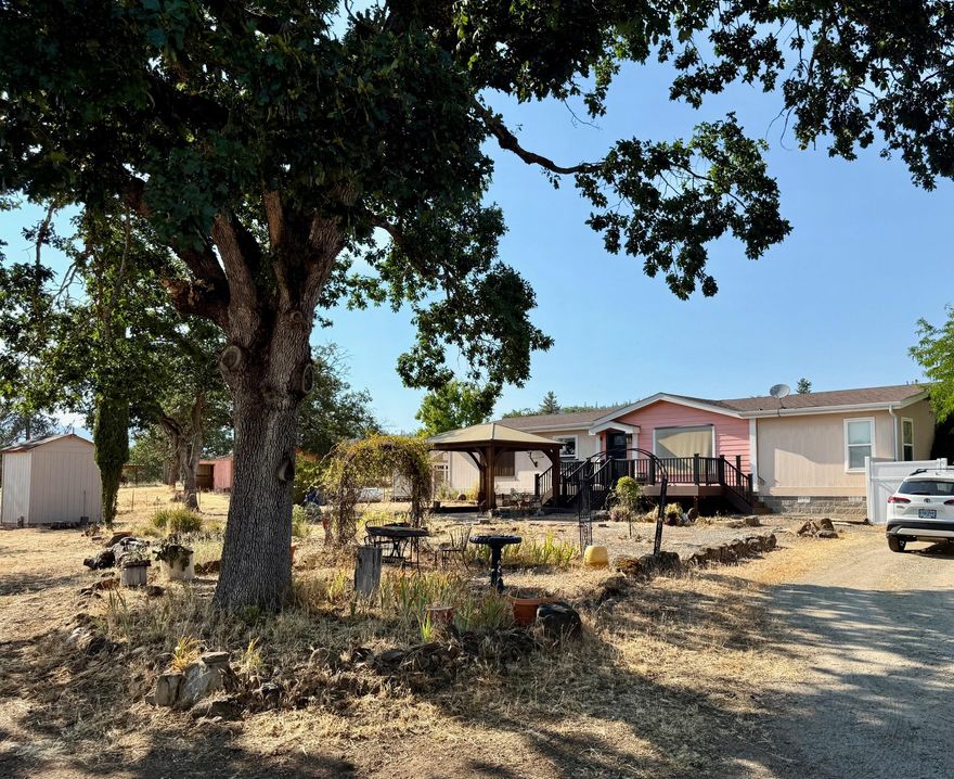 Back on market due to no fault of this property. Welcome to your peaceful country retreat! Situated on 6.50 usable acres, this beautifully maintained 2006 double-wide manufactured home offers the perfect blend of comfort, space, and rural charm. This 3 bedroom, two bath home is in excellent condition and offers a spacious floor plan ideal for both everyday living and entertaining. All three bedrooms are extra spacious and feature walk in closets. 
Ready for your animals and country lifestyle, the property is set up with fully cross-fenced pastures, a large pole barn, multiple outbuildings, and sheds—perfect for livestock, equipment storage, or hobby farming. The land offers room to roam, garden, and enjoy the serene surroundings. Whether a full-time residence, a small farm setup, or space to stretch out, this property offers an incredible opportunity at a great price. Don't miss out on this well-kept, move-in ready rural home!